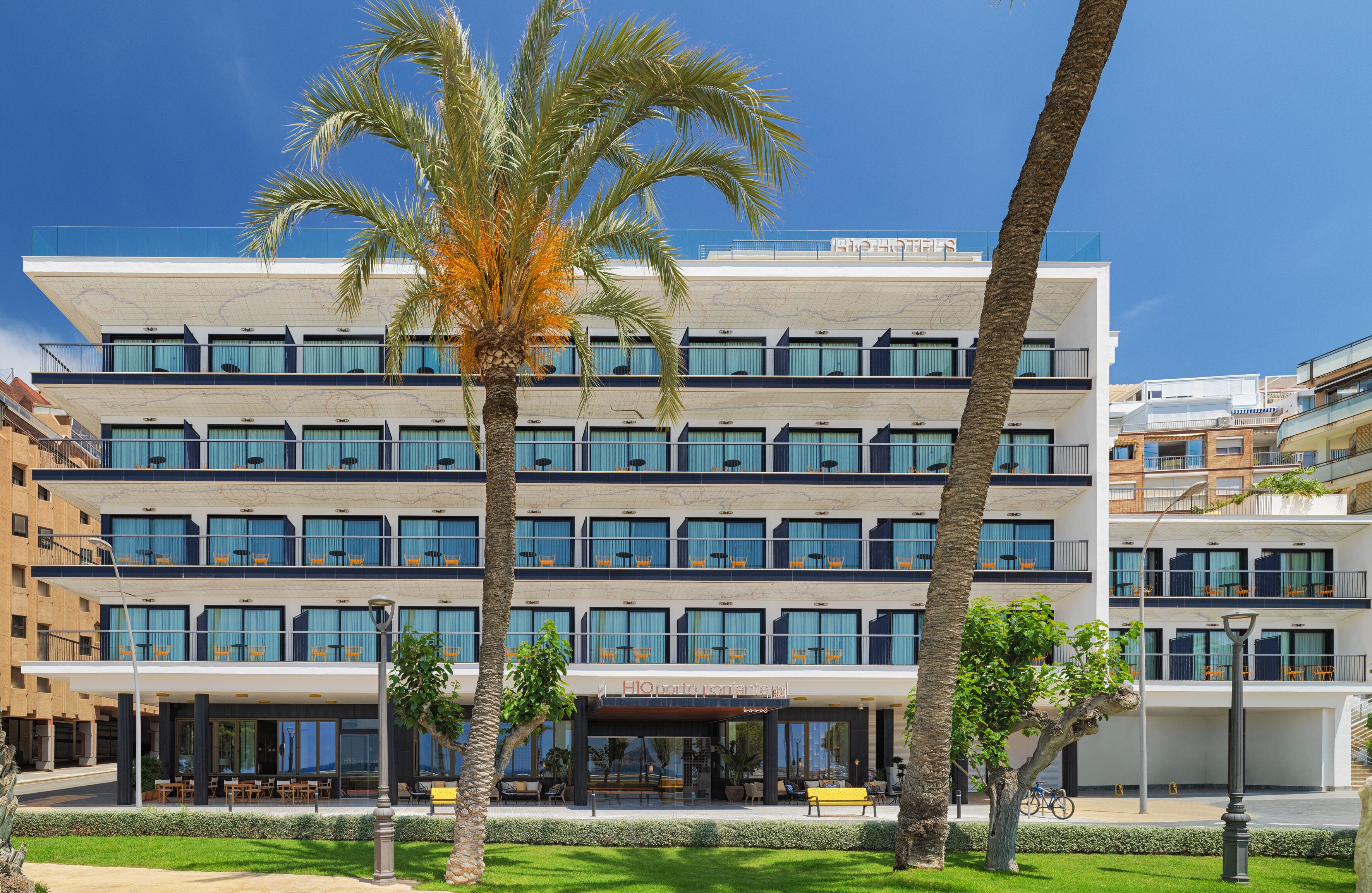 Un hotel de varios pisos con un diseño moderno, que cuenta con balcones y ventanas amplias.