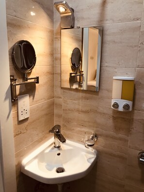 A bathroom with a sink, mirror, and a soap dispenser. - LA88 Boutique (St. Paul's Bay)