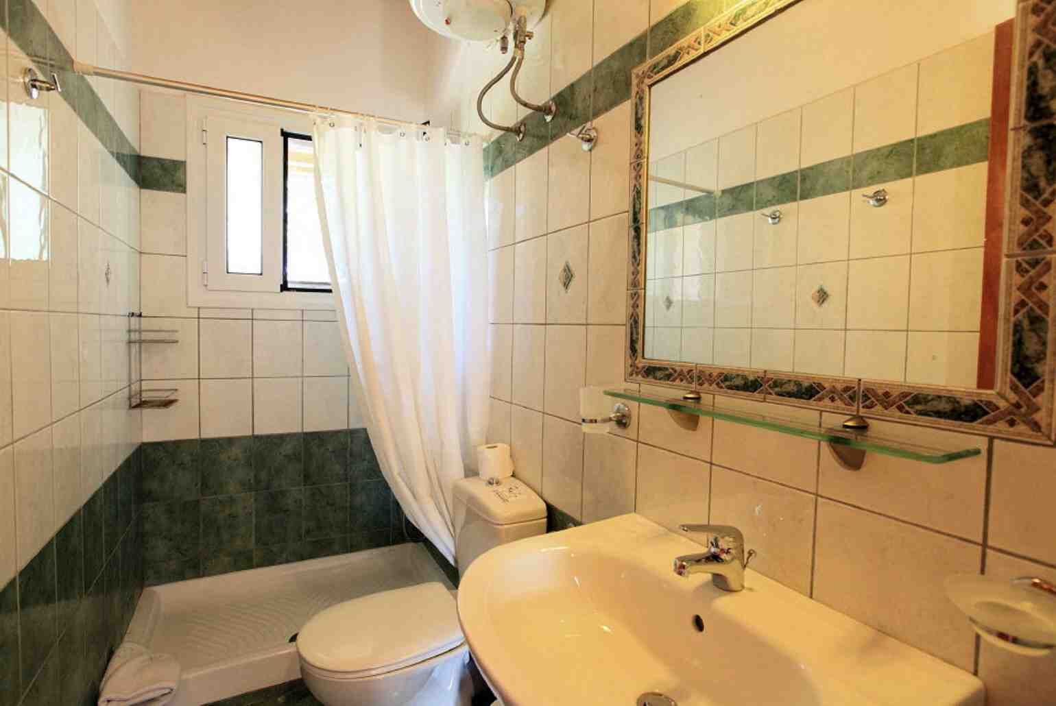 A bathroom with a bathtub, toilet, and sink.