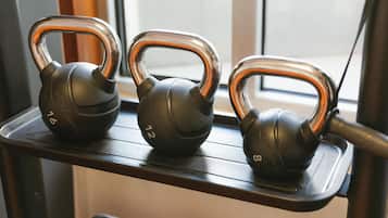 Three kettles on a shelf.
