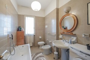 Bathtub, hair dryer, bidet, towels