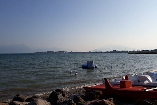 Enjoy serene lakeside views and moored boats in a peaceful environment.
