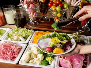 A buffet with various food items including vegetables, fruits, and salads. - JR East Hotel Mets Premier Gotanda (Tokyo)