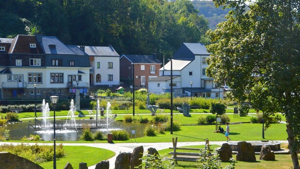 A park with a fountain, stone sculptures, and a pond. - Holiday Home in La Roche With Sauna (La Roche-en-Ardenne)