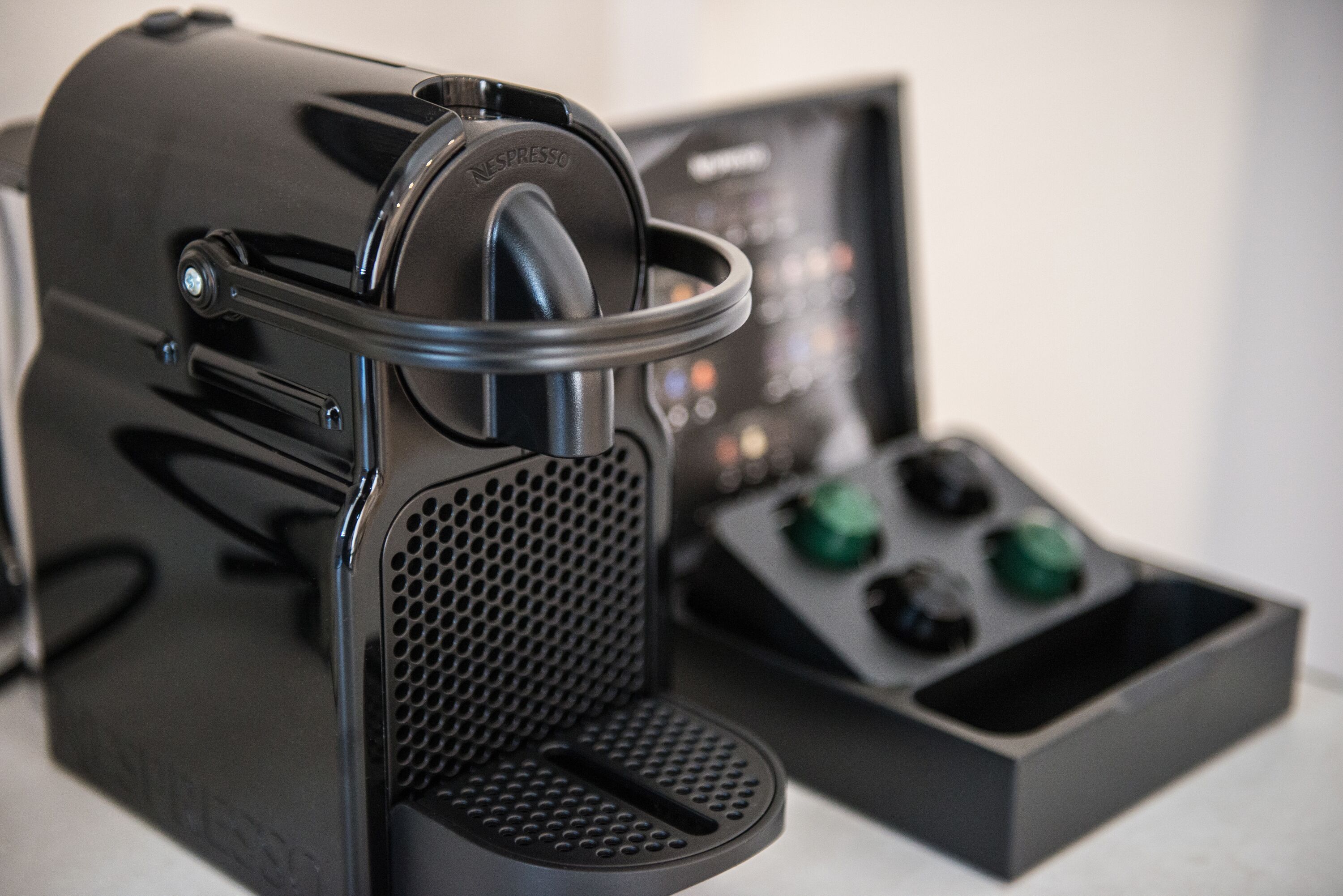 A coffee machine with a control panel and a water reservoir.