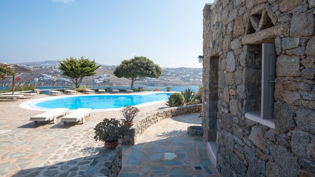 A stone building with a pool and lounge chairs. - Villa Anemoessa Sky Blue with Pool (Mykonos)