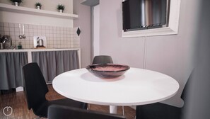 A modern kitchen with white cabinets, a stainless steel sink, and a small potted plant on the countertop. - Italianway Easy - Corso Como 8 (Milano)
