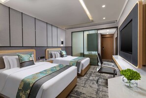 A hotel room with two beds, a TV, a desk, and a chair. - Microtel by Wyndham Hangzhou (Hangzhou)