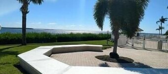 Incredible ground floor villa with water views of Bay and waterside pool!