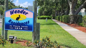 A sign for Wander Residences at Tierra Verde, 1515, with a bird graphic. - Lovely 1st Floor, 1 BR condo with garden, pool and water view in Tierra Verde (Tierra Verde)