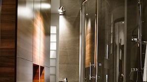 A modern bathroom with a glass-enclosed shower, a standalone sink, and wooden paneling. - Apartament balkon-Aleje Jerozolimskie 29 (Warsaw)