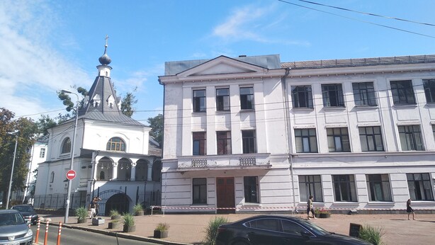A building with a classical architectural style, featuring a prominent central dome and a symmetrical facade with evenly spaced windows.