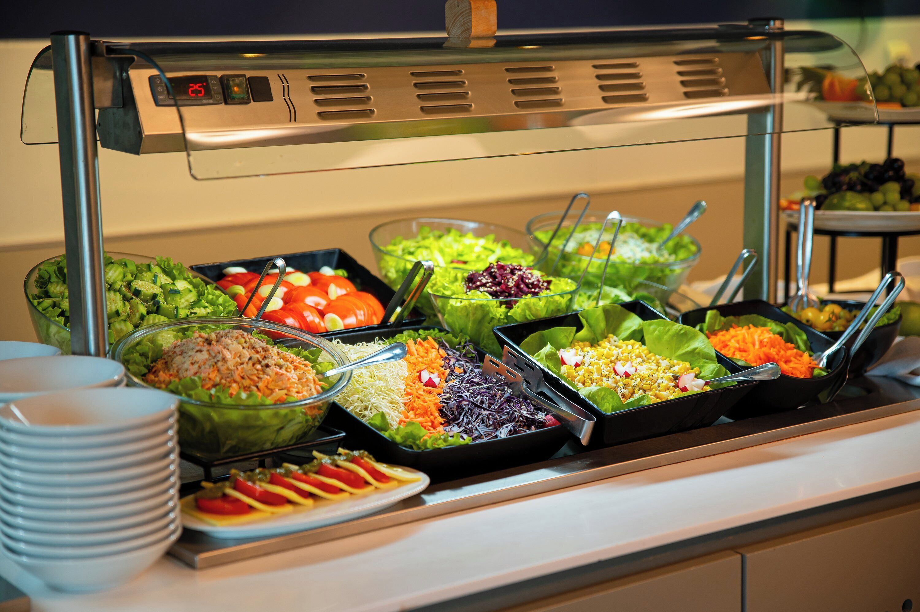 A buffet with various salads and dishes.