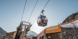 A cable car system with a clear sky and mountains in the background.