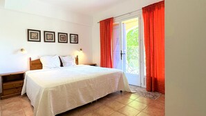 A bedroom with a bed, two bedside tables, a nightstand, a door with a view, and three framed pictures on the wall. - Grand F3 - Apartment for 4 to 6 people (Figanières)