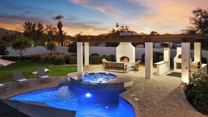 An outdoor patio with a hot tub, seating area, and a fireplace. - Paradise Valley 6BR Retreat - Heated Pool, Spa, Wood-Fired Pizza Oven & Views (Paradise Valley)