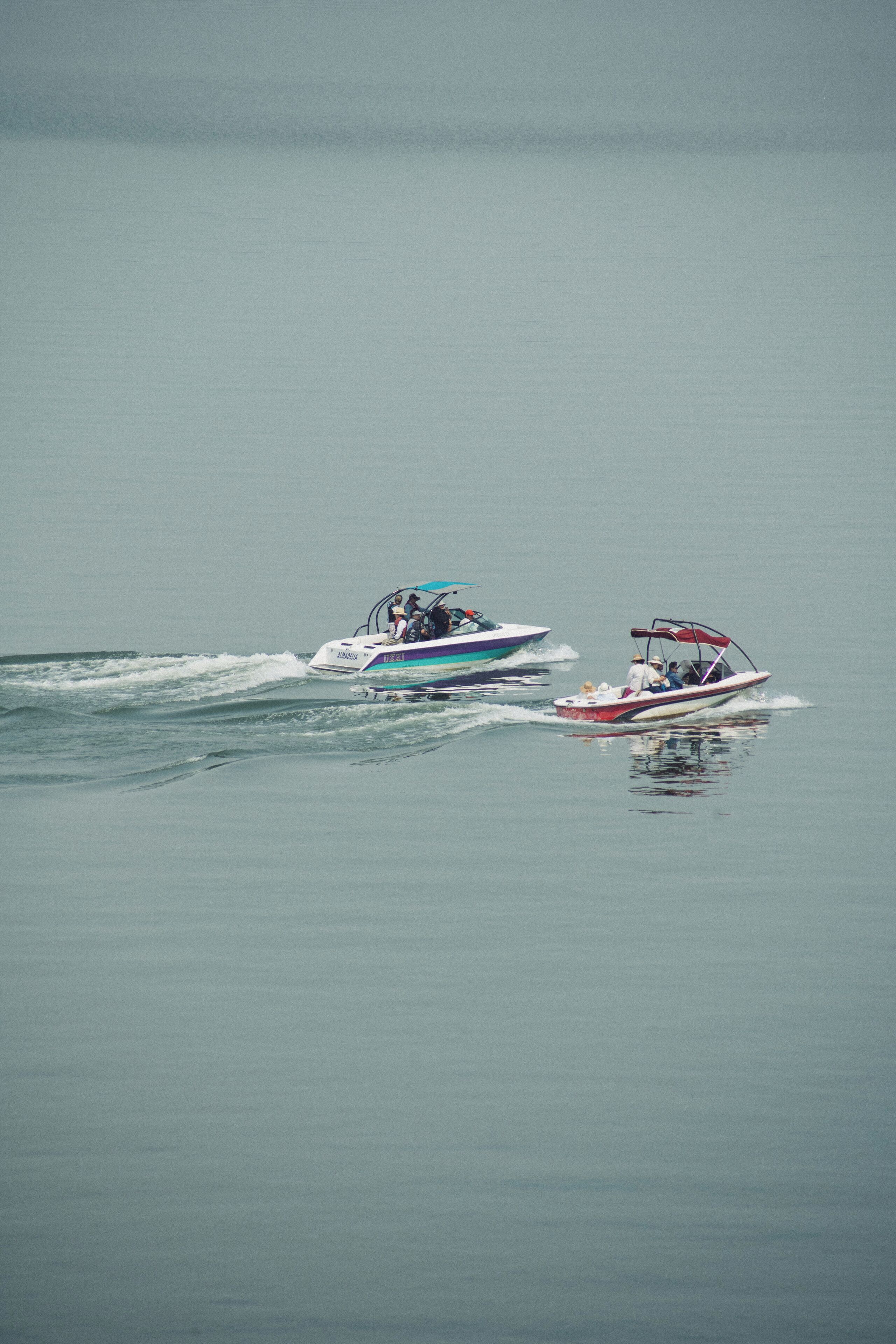 Two boats on a calm body of water.