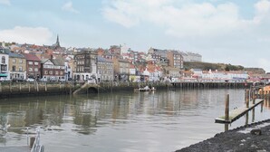 A waterfront view with buildings, a dock, and a pier. - 3 bedroom accommodation in Whitby (Whitby)