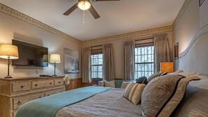 A bedroom with a large bed, a ceiling fan, a flat-screen TV, and a dresser. - 2 Br: Whistlepunk 28 (Snowshoe)