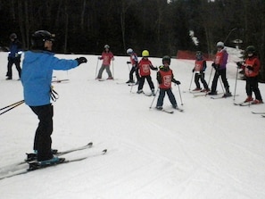 A group of people skiing on a snowy slope. - 0 Br : Soaring Eagle 308 (Snowshoe)