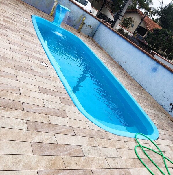 Relax by the pool surrounded by lush surroundings.