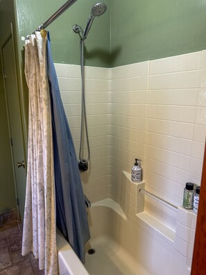 Bathtub, hair dryer, towels, soap