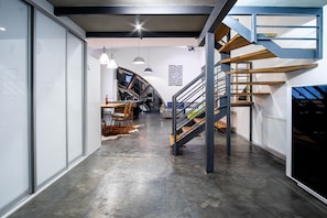 Stunning staircase leads to an upper level in this modern space with polished concrete floors and clean lines.