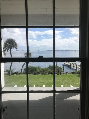 Guests can enjoy a serene view of the lake with a sailboat in the distance from their room.