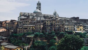 A historic cityscape with a prominent cathedral and surrounding buildings. - Rinidia Siena Celso Cittadini Grande (Siena)