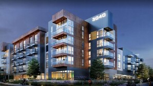 A modern multi-story building with balconies, large windows, and a sign indicating the address 3040. - Bell Overlake (Redmond)