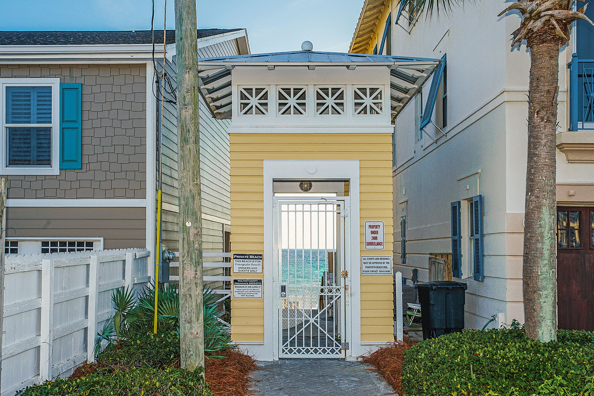 A gated entrance to a private beach property with a sign indicating it is for guests only.