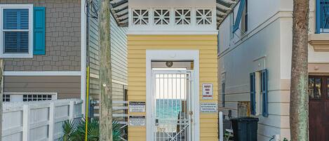 A gated entrance to a private beach property with a sign indicating it is for guests only.