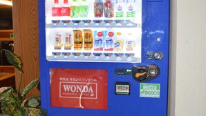 A vending machine with various drinks and a Wonda coffee label.