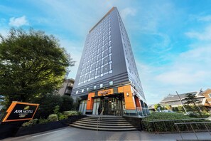 A modern hotel with a prominent entrance, a staircase leading to the lobby, and a clear sky. - APA Hotel Chiba Ekimae (Chiba)