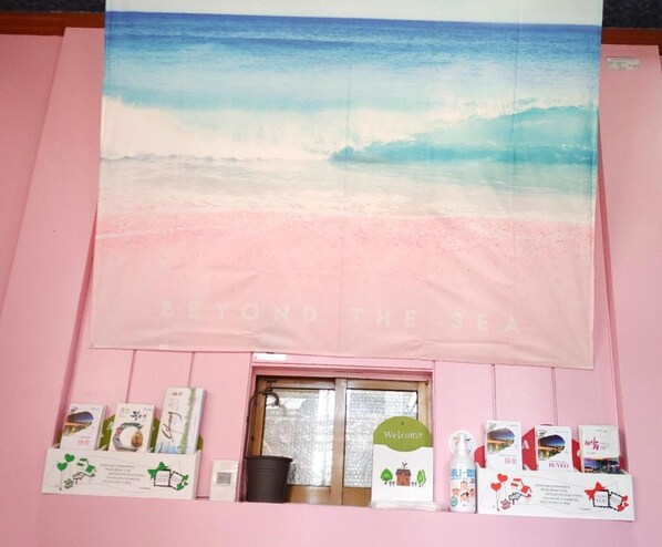 A room with a large beach-themed poster, a window, and various informational cards on the wall. - Healinghouse Peakjang (Buyeo)