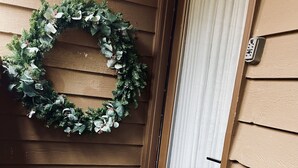 A wooden exterior with a wreath on the door and a doormat at the entrance. - Newly Updated Cozy Condo in the Heart of Wintergreen!  Pet friendly. (Wintergreen)