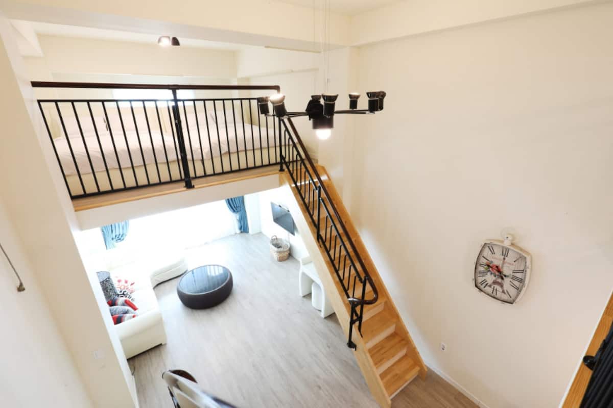 Deluxe Duplex | Living area | Flat-screen TV