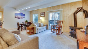 A cozy living room with a sofa, a dining table, and a fireplace. - Breckenridge Condo w/ Spa Access: Walk to Ski Lift (Breckenridge)
