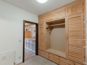 Spacious room with a wardrobe and door to adjacent room.