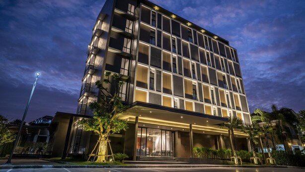 A modern hotel with a multi-story structure, large windows, and a covered entrance area. - Xotel (Khon Kaen)