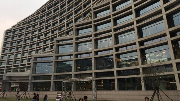A modern building with a grid-like facade and numerous windows. - Dongqu Light Inn (Taipei)