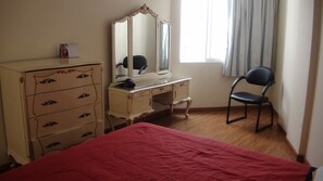 Relax in this inviting space with a comfortable bed, dresser, and chair.