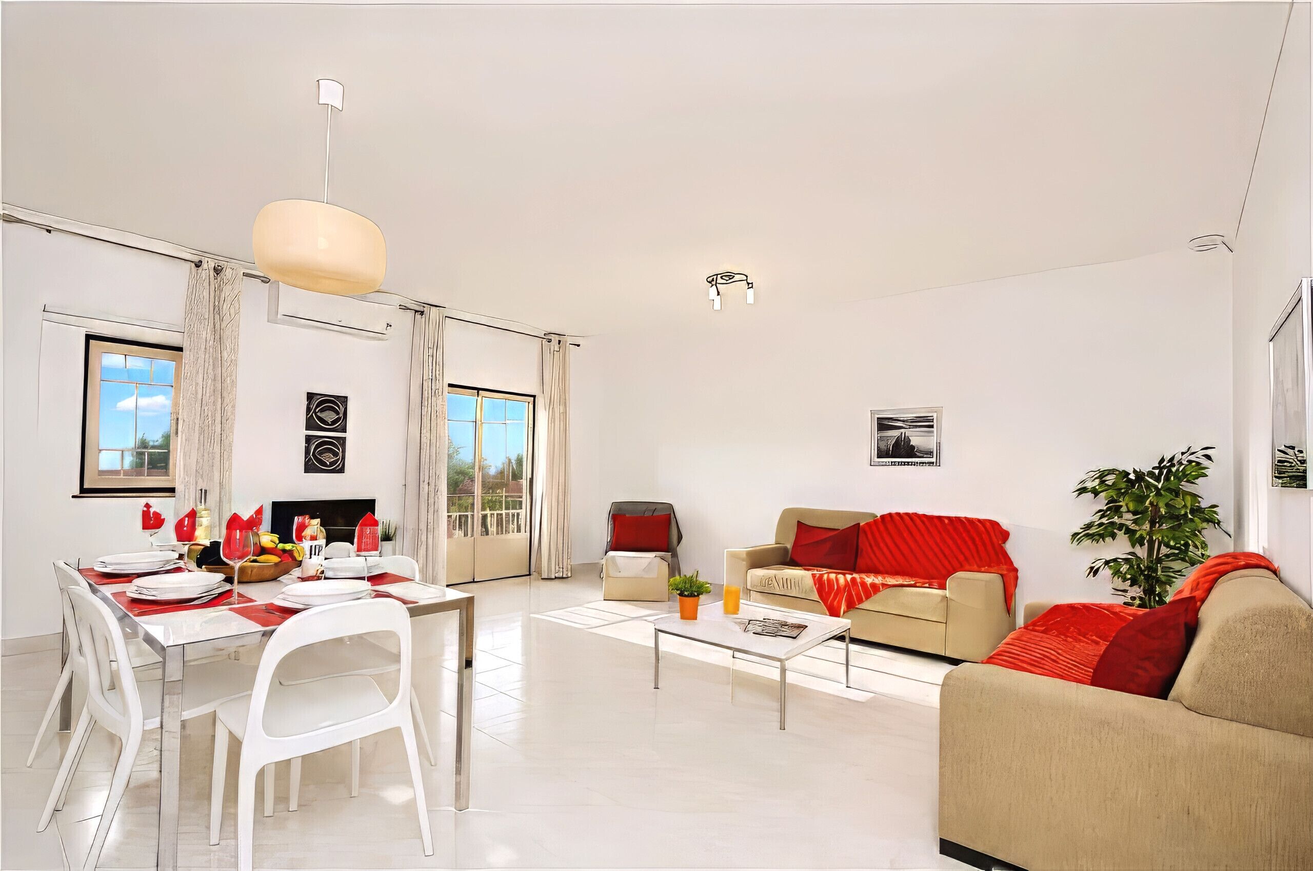 A modern living room with a dining area, a sofa, a coffee table, and a fireplace.