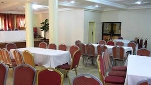 A conference room with multiple tables and chairs, arranged in rows. - Calabar Grand Hotel (Calabar)