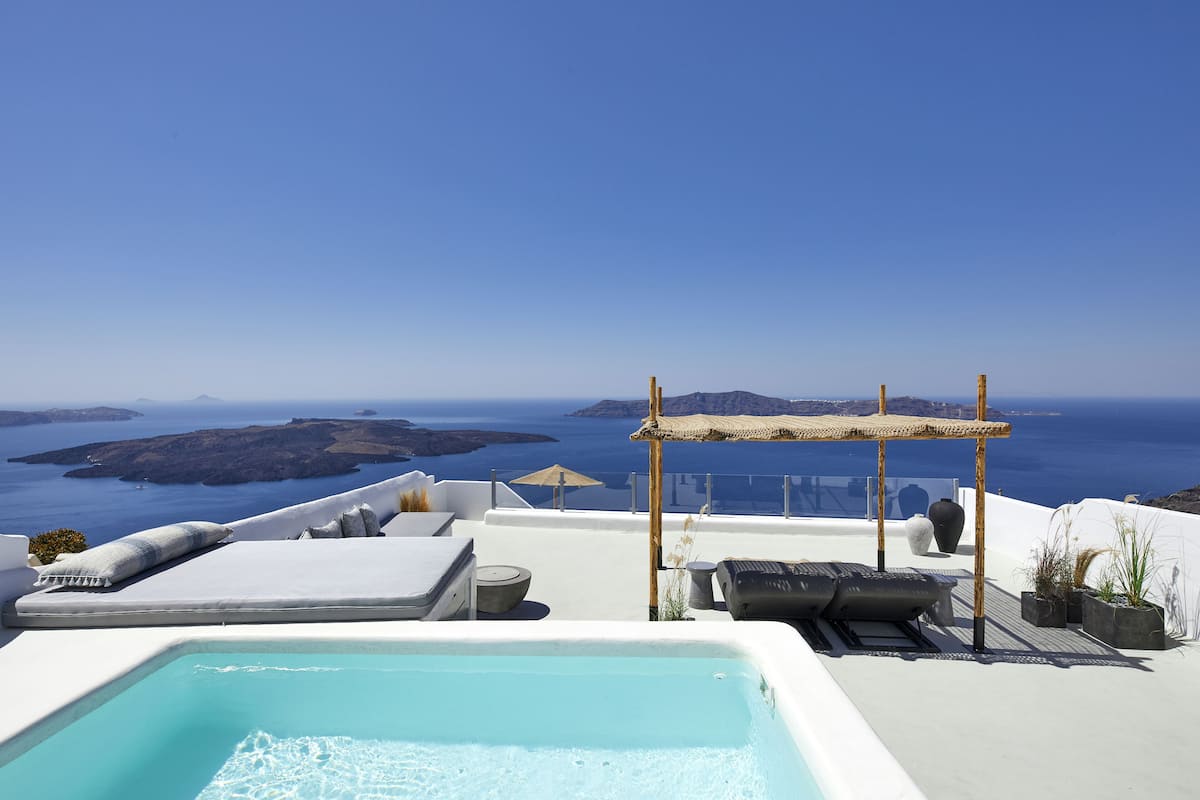 A rooftop pool with a view of the sea and islands.