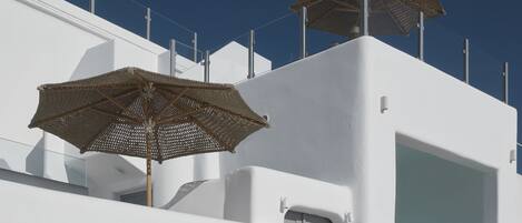 A white building with a sign reading "YOU AND ME - SUITES SANTORINI-".