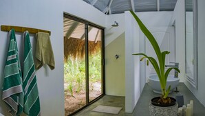 A bathroom with a large window, a sink, and a potted plant. - Maqueda @ Mozambique (Manhica)