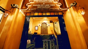 The entrance of The Lake View Hotel on Pichola Lake & Nazara by Lake View Restaurant with a traditional design and a staircase leading inside. - The Lake View Hotel – On Lake Pichola (Udaipur)