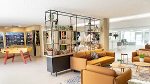 A modern living room with a sofa set, a coffee table, and a decorative glass partition with shelves. - Residhome Toulouse Ponts Jumeaux (Toulouse)