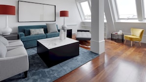 A modern living room with a sofa, armchairs, a coffee table, and a yellow chair. - Playa de La Concha 7 by FeelFree Rentals (Donostia)